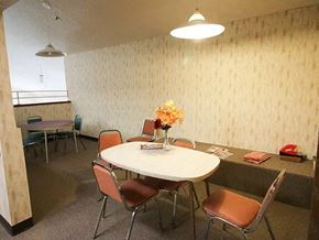 Wahoo apartment for rent - A conference room with a round table and chairs.