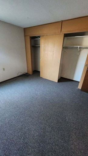 Harlan apartment for rent - an empty room with a closet and a door open