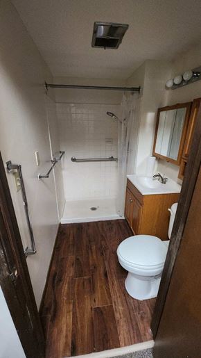 Harlan apartment for rent - a bathroom with a toilet a sink and a shower