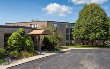 Springfield apartment for rent - A building with a grey roof and a tree in front of it.
