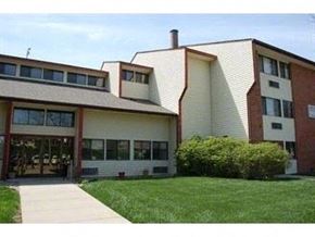 Wahoo apartment for rent - a large building with a lawn in front of it