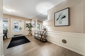 Mayfield Heights apartment for rent - A hallway with a black rug and a framed picture on the wall.