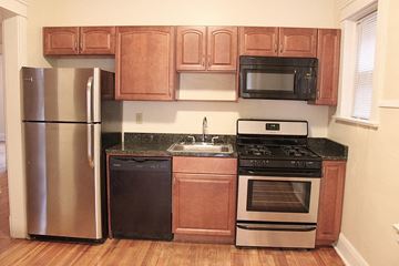Cleveland Heights apartment for rent - a kitchen with stainless steel appliances and wooden cabinets