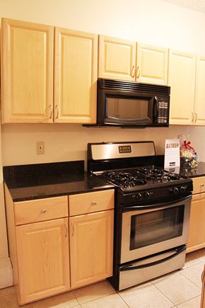 Cleveland Heights apartment for rent - a kitchen with a stove microwave and cabinets