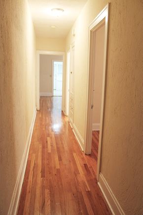 Cleveland Heights apartment for rent - a hallway with wood flooring and a door to a bedroom