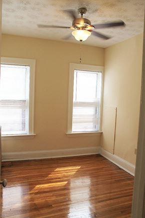 Cleveland Heights apartment for rent - an empty room with a ceiling fan and two windows