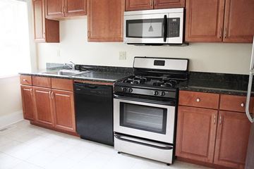 Cleveland Heights apartment for rent - a kitchen with a stove microwave and cabinets