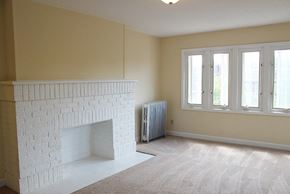 Cleveland Heights apartment for rent - A white fireplace in a carpeted living room.