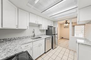 Cleveland apartment for rent - A kitchen with white cabinets and granite countertops.