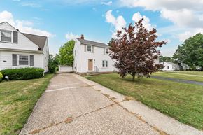 Mayfield Heights house for rent - A white house with a brown tree in front of it.