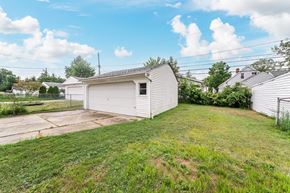Mayfield Heights house for rent - A white garage with a green lawn in front.