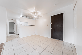 Kent apartment for rent - A room with a black door and a ceiling fan.
