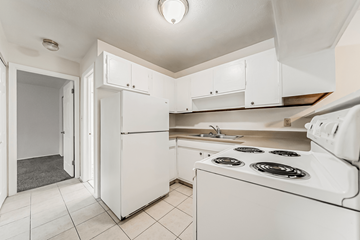 Kent apartment for rent - A white kitchen with a stove and a refrigerator.