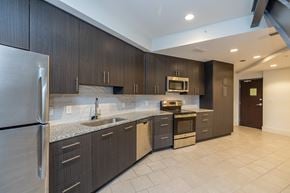 Lakewood apartment for rent - the private kitchen has stainless steel appliances and granite counter tops and dark wood cabinets