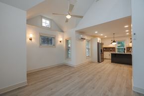Chagrin Falls triplex for rent - A spacious room with wooden flooring and a ceiling fan.
