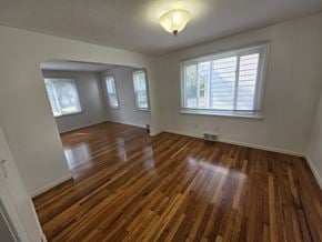 Mentor house for rent - A room with wooden floors and white walls.