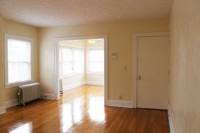 Cleveland Heights apartment for rent - an empty living room with wood floors and a door