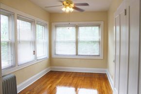 Cleveland Heights apartment for rent - an empty room with a ceiling fan and three windows