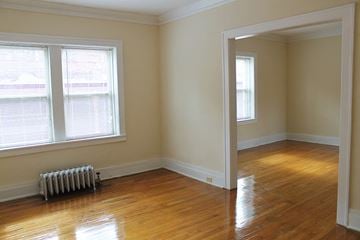 Cleveland Heights apartment for rent - an empty room with a wood floor and a radiator