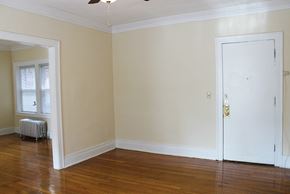 Cleveland Heights apartment for rent - an empty living room with a white door and wood floors