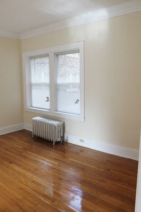 Cleveland Heights apartment for rent - a room with a wood floor and a radiator and a window
