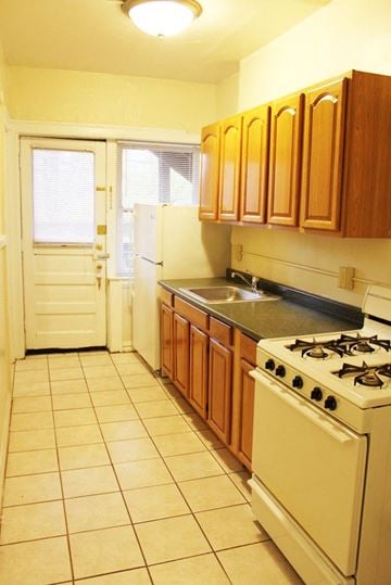 Cleveland Heights apartment for rent - a kitchen with a stove and a sink and a door