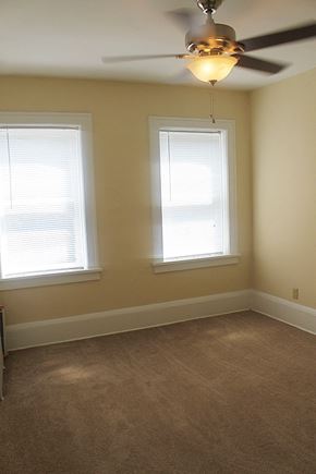 Cleveland Heights apartment for rent - a living room with two windows and a ceiling fan