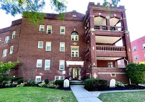 Cleveland Heights apartment for rent - A red brick building with a green tree on top at Integrity Cleveland Heights Apartments, Cleveland Heights, Ohio