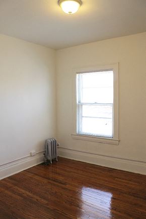 Cleveland Heights apartment for rent - an empty room with a suitcase on the floor and a window
