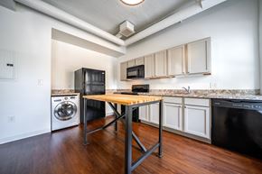 Cleveland apartment for rent - A kitchen with black appliances and wooden floors.