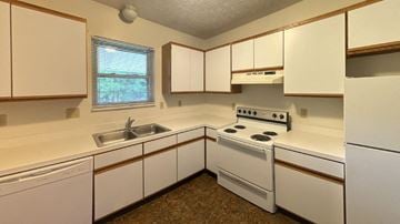 Kent apartment for rent - a kitchen with white appliances and white cabinets
