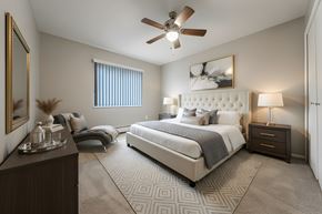 Mayfield Heights apartment for rent - A bedroom with a large bed, a ceiling fan, and a nightstand with a lamp.