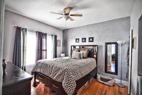 Cleveland apartment for rent - a bedroom with a bed and a ceiling fan