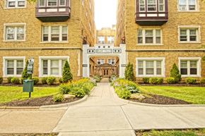 Cleveland apartment for rent - the front entrance of a building with a sidewalk and grass