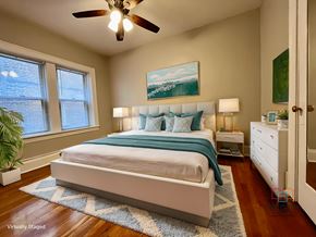 Cleveland Heights apartment for rent - A bedroom with a bed, nightstand, and a ceiling fan.