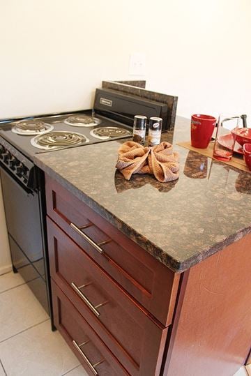 Berea apartment for rent - A kitchen counter with a stove top and a red cup on it.
