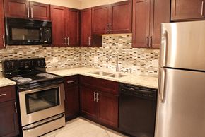 Cleveland Heights apartment for rent - a kitchen with wooden cabinets and stainless steel appliances