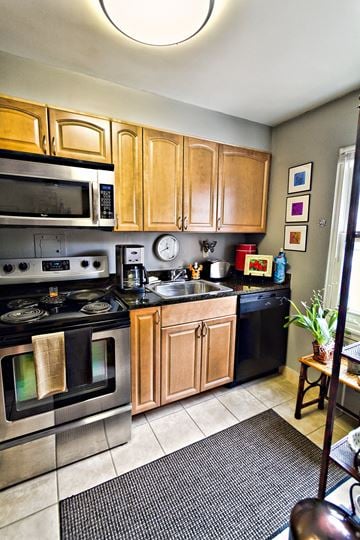Lakewood apartment for rent - a kitchen with stainless steel appliances and wooden cabinets
