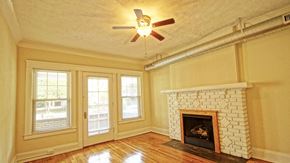 Cleveland Heights apartment for rent - A room with a fireplace and a ceiling fan.