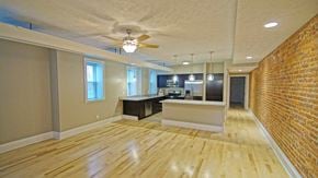 Cleveland Heights apartment for rent - an empty living room with a brick wall and a ceiling fan