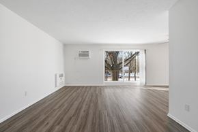 Mayfield Heights apartment for rent - Updated Wynwood great room with sliding glass door to balcony and plank flooring.