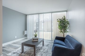 Kent apartment for rent - a living room with a blue couch and a coffee table