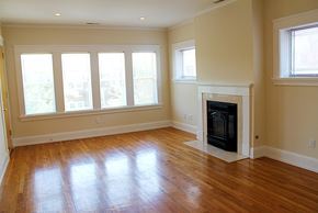 Cleveland Heights apartment for rent - an empty living room with a fireplace and wooden floors