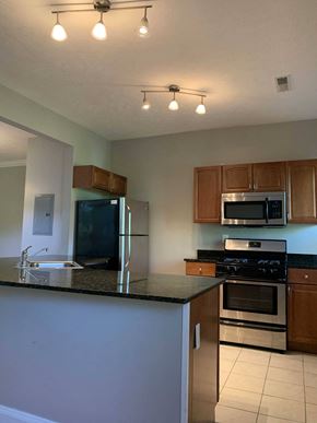 Cleveland Heights apartment for rent - A kitchen with a black counter top and stainless steel appliances.