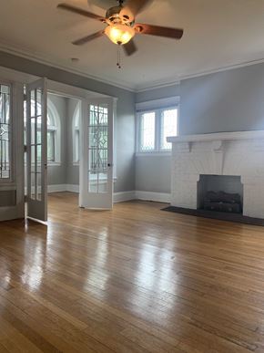 Cleveland Heights apartment for rent - an empty living room with a fireplace and a ceiling fan
