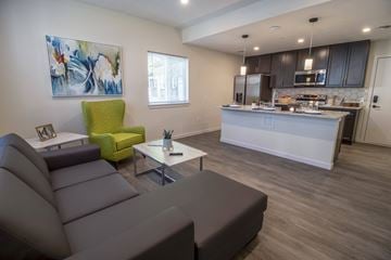 Cleveland Heights apartment for rent - a living room and kitchen with a couch and a table