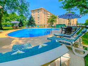 Westlake apartment for rent - Blue Swimming Pool with Shaded Lounge Chairs at Westwood Meadows, Westlake, OH, 44145