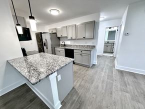 Beachwood apartment for rent - A kitchen with a granite countertop and wooden flooring Old Green Place Apartments, Beachwood, OH