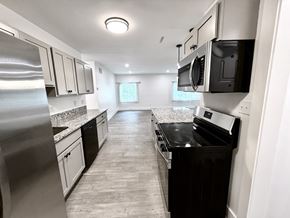 Beachwood apartment for rent - A modern kitchen with stainless steel appliances and black countertops Old Green Place Apartments, Beachwood, OH