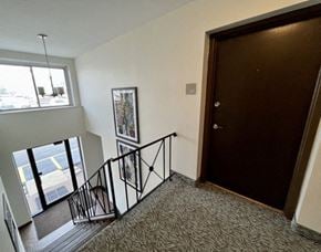 Woodmere apartment for rent - a view from the top of the stairs looking down at the door
